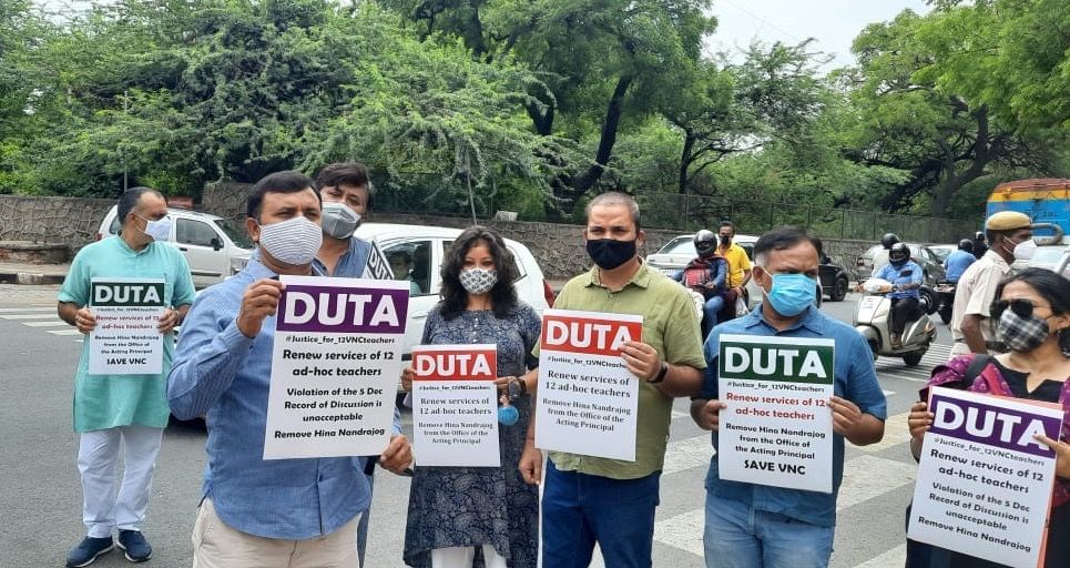 Teachers hold DUTA placards at a roadside protest